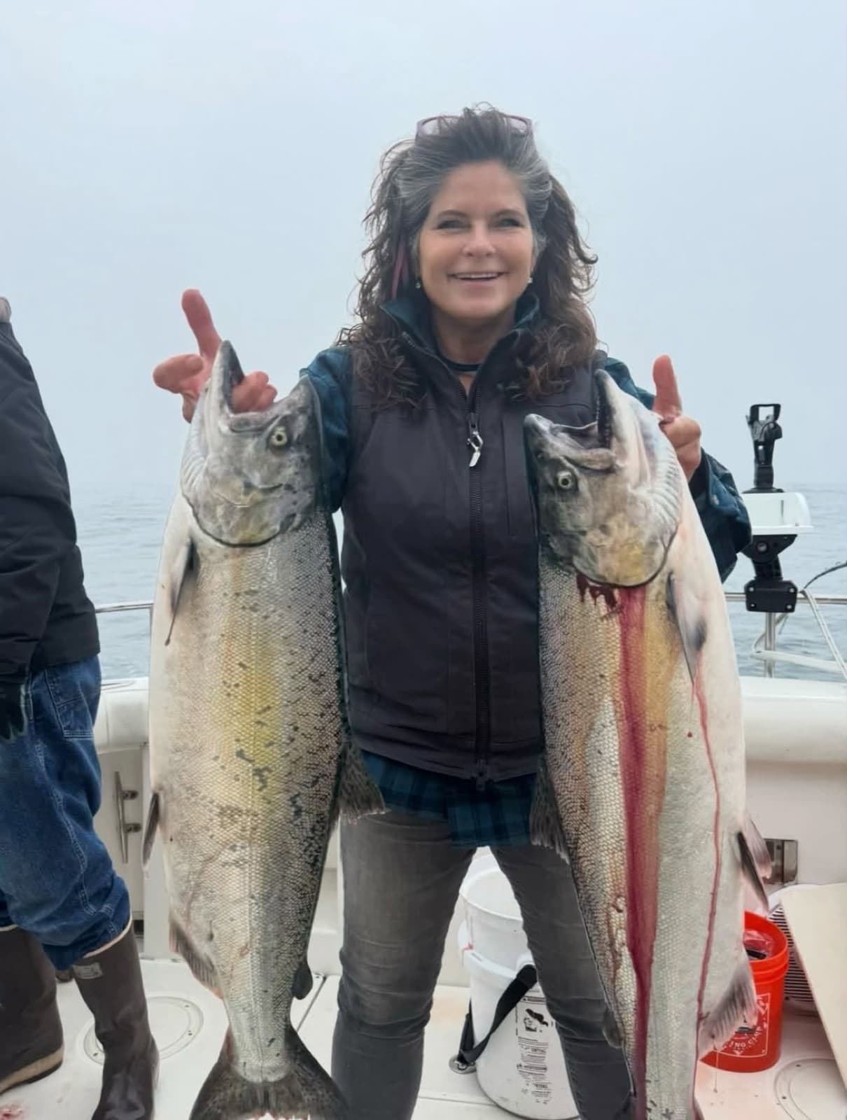 An angler with two salmon on a Molly's Boats charter